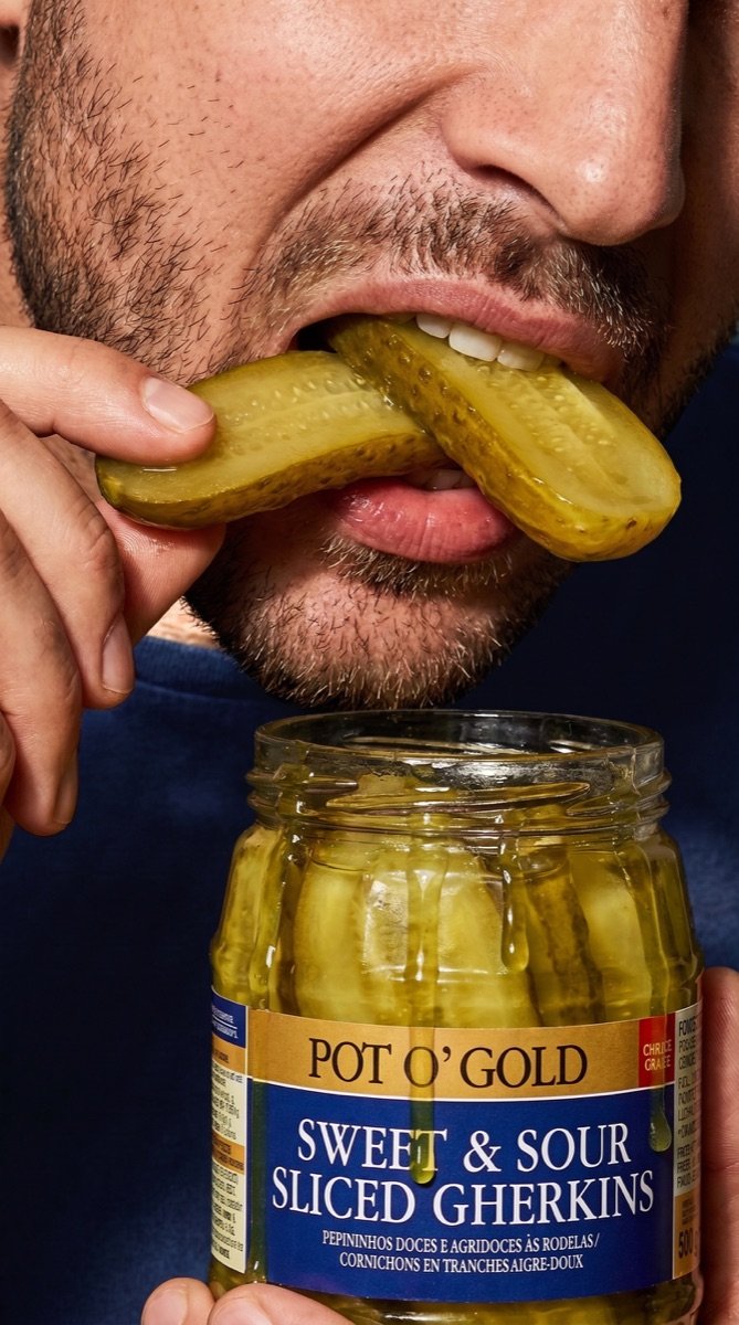 Close-up of a man biting sliced gherkins